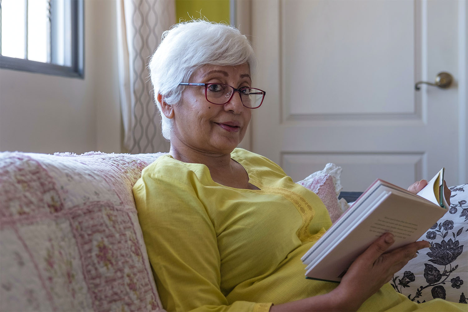 resident reading and smiling