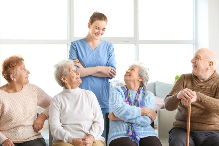nurse with residents smiling